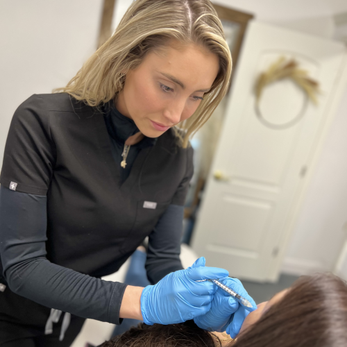 Woman receiving dermal filler treatment at StarBella Spa or Relaxing spa environment for wrinkle treatments.